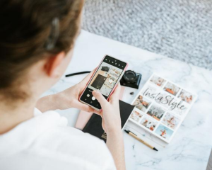 Business owner creating Instagram content on a smartphone while planning Social Media Marketing Strategies for Small Businesses to increase engagement and brand awareness.